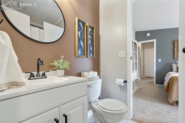 full bath with vanity, toilet, a textured ceiling, and baseboards