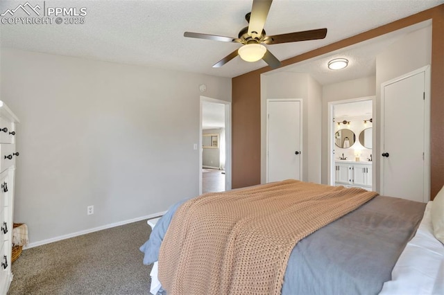 bedroom featuring carpet flooring, baseboards, a ceiling fan, and ensuite bathroom