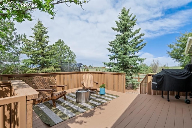 wooden deck featuring area for grilling