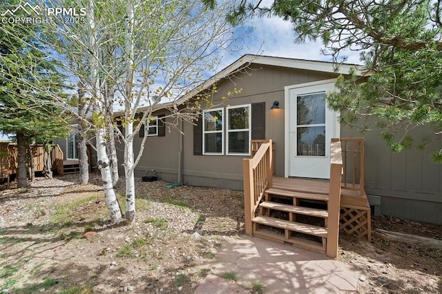 view of front of home with a wooden deck and fence