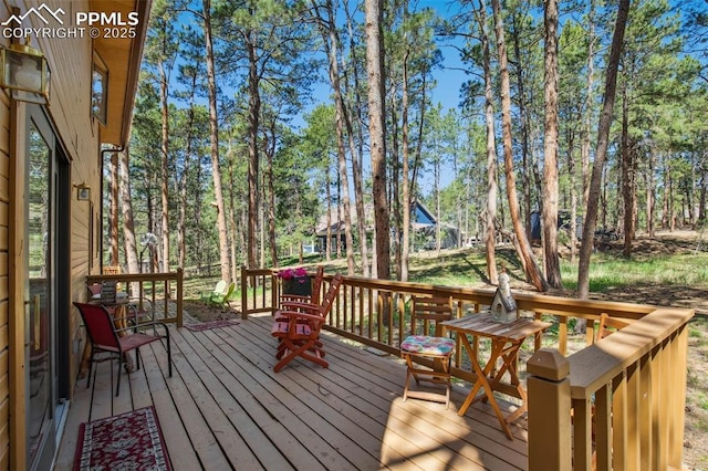 18045 Woodhaven Pl, Colorado Springs, CO 80908 - wooden deck with view of wooded area