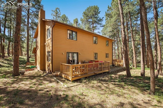 18045 Woodhaven Pl, Colorado Springs, CO 80908 - back of house featuring a chimney, a deck, and french doors