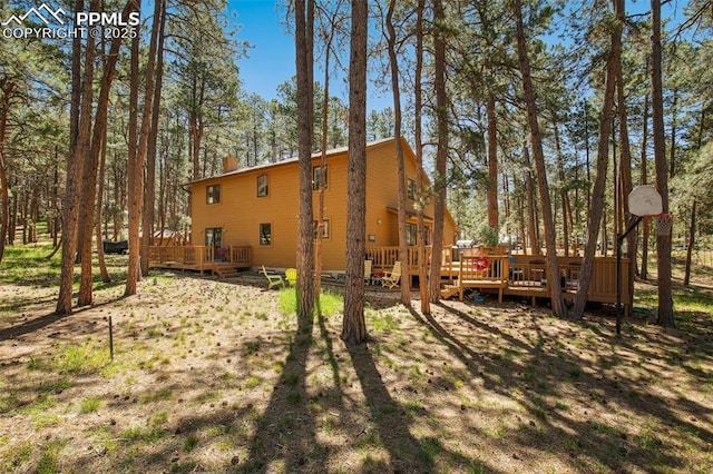 18045 Woodhaven Pl, Colorado Springs, CO 80908 - back of property featuring a deck and view of scattered trees