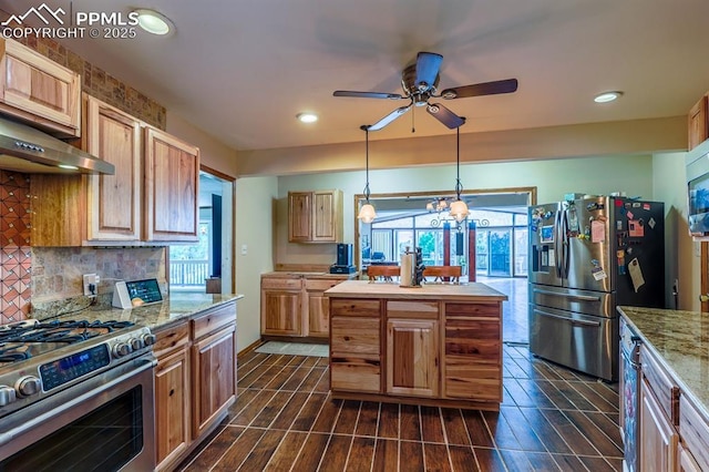 2760 Evergreen Rd, Colorado Springs, CO 80921 - kitchen featuring appliances with stainless steel finishes, under cabinet range hood, tasteful backsplash, ceiling fan, and light stone countertops