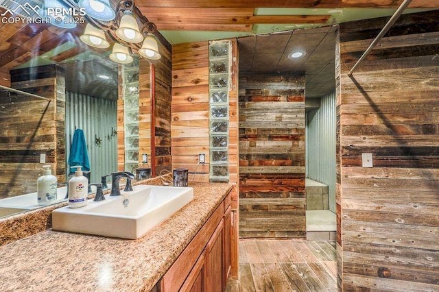 2760 Evergreen Rd, Colorado Springs, CO 80921 - bathroom with wooden walls, vanity, and wood finished floors