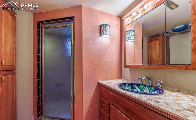 2760 Evergreen Rd, Colorado Springs, CO 80921 - full bath featuring a textured wall, vanity, and a shower stall