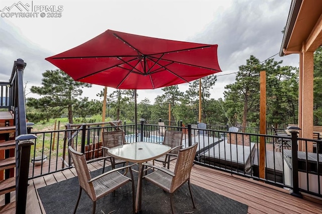 2760 Evergreen Rd, Colorado Springs, CO 80921 - wooden deck featuring outdoor dining area and view of wooded area