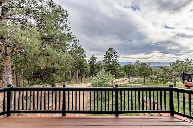 2760 Evergreen Rd, Colorado Springs, CO 80921 - wooden deck with view of scattered trees