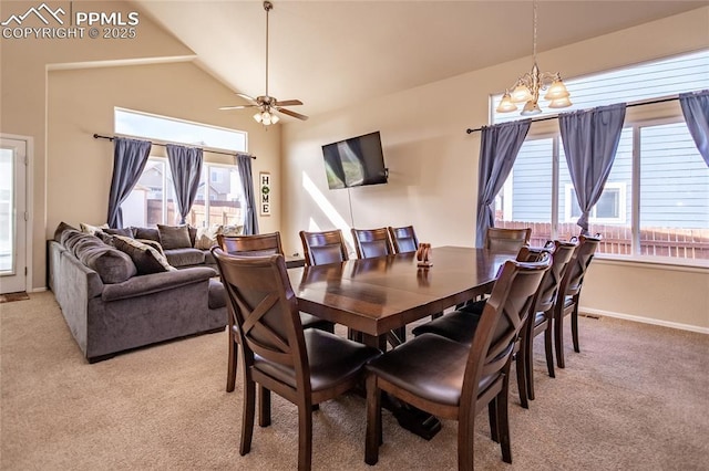 dining area featuring light colored carpet, a chandelier, plenty of natural light, and lofted ceiling