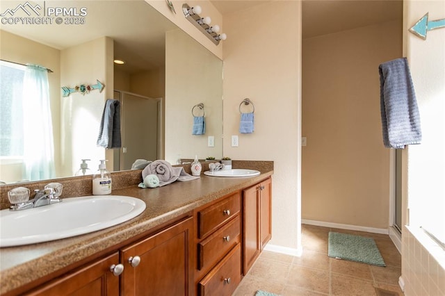 bathroom with a stall shower, double vanity, and tile patterned floors