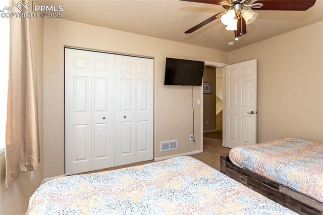 bedroom featuring a closet, carpet flooring, ceiling fan, and baseboards