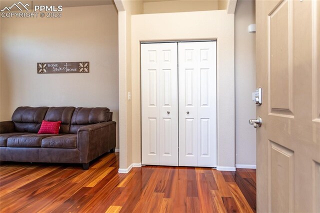 living room with dark wood finished floors and baseboards