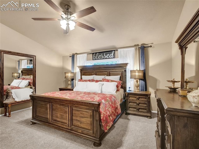 bedroom featuring light colored carpet, lofted ceiling, and a ceiling fan