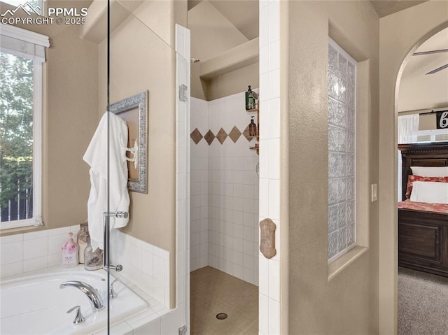 bathroom with a walk in shower and a garden tub