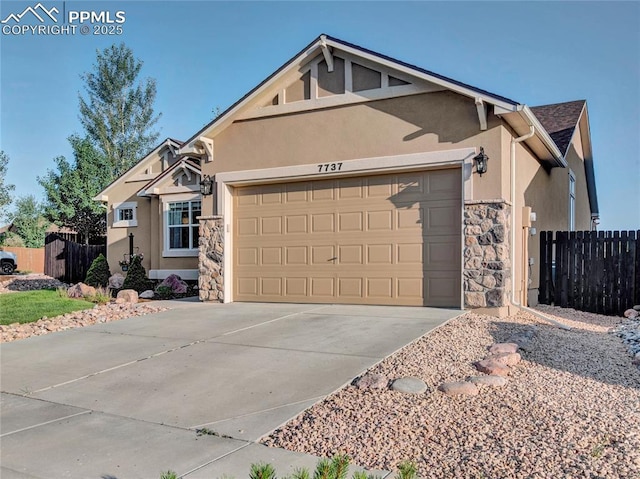 view of front of property with stone siding, a garage, and stucco siding