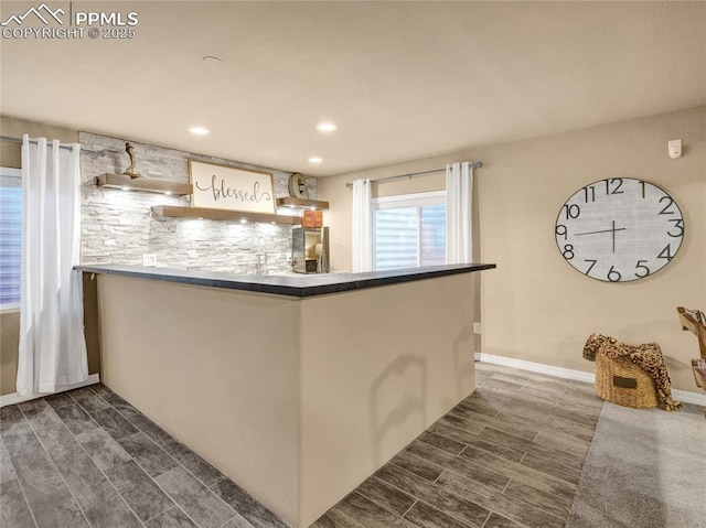 indoor bar with wood tiled floors, recessed lighting, decorative backsplash, and wall chimney exhaust hood