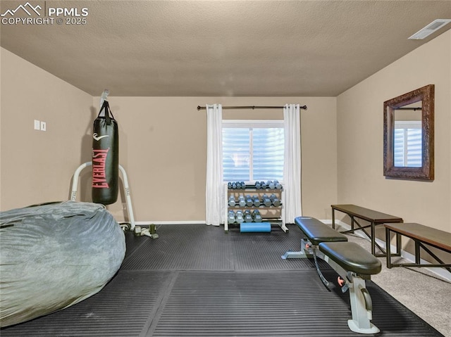 exercise room featuring carpet flooring and baseboards
