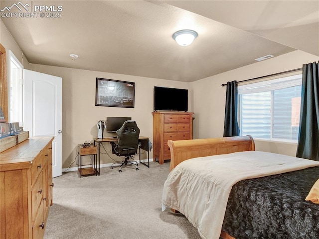 bedroom with light carpet and baseboards