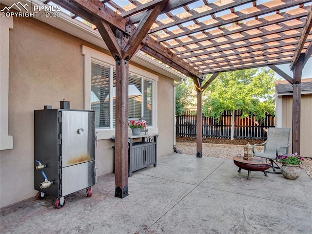 view of patio featuring fence and a pergola