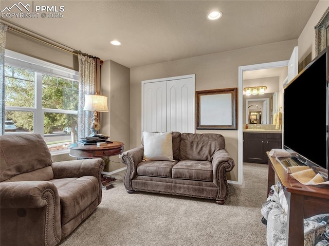 living area featuring carpet flooring, baseboards, and recessed lighting