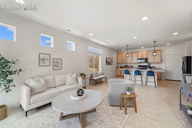living room featuring recessed lighting and baseboards