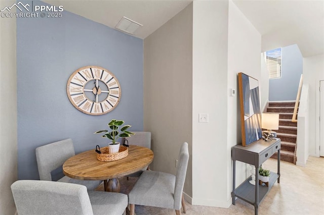 dining area featuring stairs and baseboards