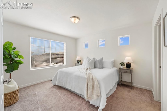 bedroom featuring light colored carpet and baseboards