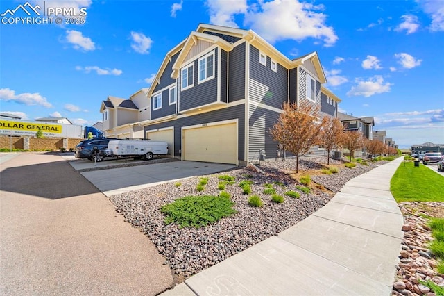 view of property exterior featuring driveway, an attached garage, and a residential view