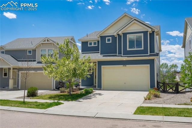 craftsman-style home with a garage, board and batten siding, driveway, fence, and roof with shingles