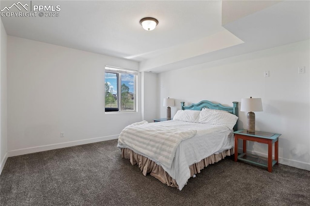 bedroom with baseboards and dark colored carpet