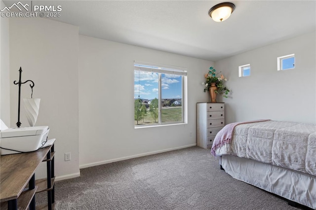 carpeted bedroom with baseboards and an office area
