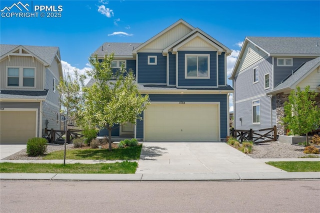 craftsman inspired home featuring a garage and driveway