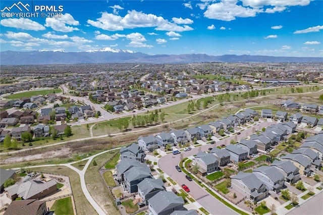 aerial overview of property's location featuring nearby suburban area and a mountainous background