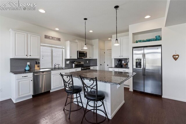 kitchen with appliances with stainless steel finishes, a sink, open shelves, white cabinets, and recessed lighting