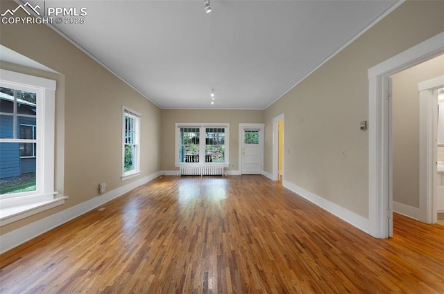 1505 Cheyenne Blvd, Colorado Springs, CO 80906 - unfurnished room featuring radiator, crown molding, wood finished floors, and baseboards