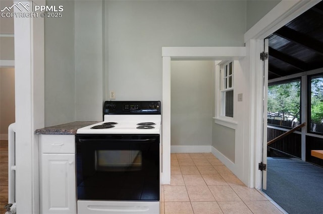 1505 Cheyenne Blvd, Colorado Springs, CO 80906 - kitchen featuring electric stove, dark countertops, white cabinetry, light tile patterned flooring, and baseboards