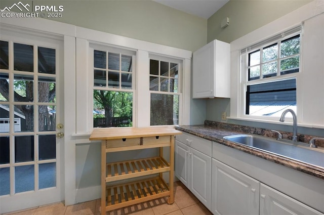 1505 Cheyenne Blvd, Colorado Springs, CO 80906 - kitchen with a sink, white cabinetry, and light tile patterned floors
