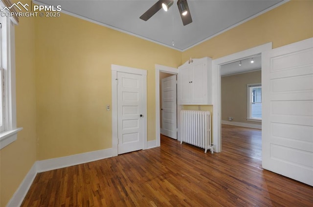 1505 Cheyenne Blvd, Colorado Springs, CO 80906 - unfurnished room featuring radiator, a ceiling fan, wood finished floors, baseboards, and crown molding
