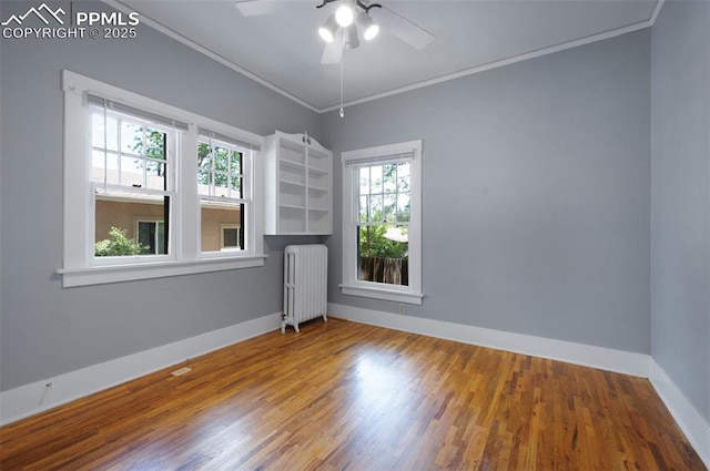 1505 Cheyenne Blvd, Colorado Springs, CO 80906 - spare room featuring radiator heating unit, wood finished floors, crown molding, a ceiling fan, and baseboards
