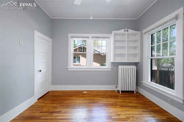 1505 Cheyenne Blvd, Colorado Springs, CO 80906 - spare room featuring radiator, crown molding, healthy amount of natural light, and wood finished floors