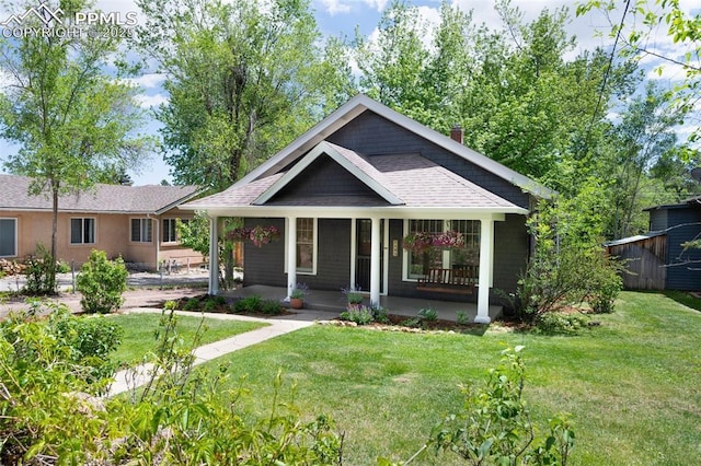 1505 Cheyenne Blvd, Colorado Springs, CO 80906 - view of front of house with a porch, a front lawn, a chimney, and roof with shingles