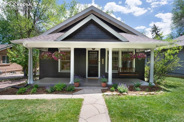 1505 Cheyenne Blvd, Colorado Springs, CO 80906 - view of front of home with covered porch, a front yard, and a shingled roof