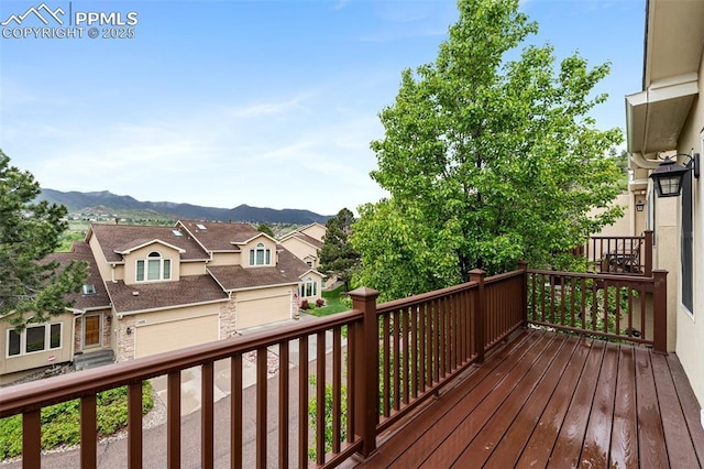 1433 Ledge Rock Ter, Colorado Springs, CO 80919 - wooden deck featuring a mountain view, a garage, and a residential view