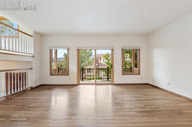 1433 Ledge Rock Ter, Colorado Springs, CO 80919 - unfurnished living room featuring wood finished floors and baseboards