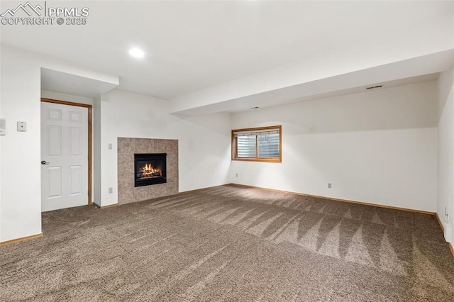 1433 Ledge Rock Ter, Colorado Springs, CO 80919 - unfurnished living room with carpet flooring, baseboards, a tiled fireplace, and recessed lighting