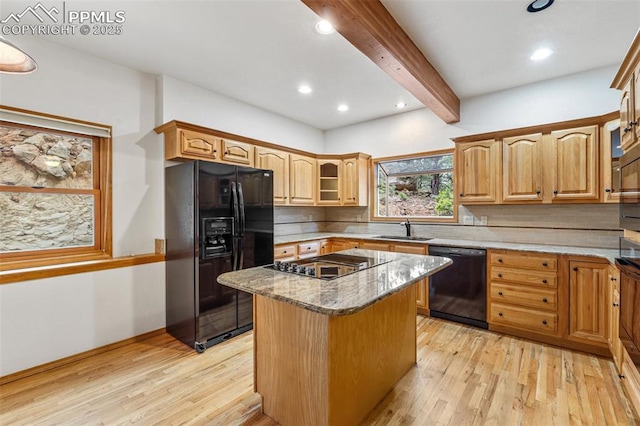 1433 Ledge Rock Ter, Colorado Springs, CO 80919 - kitchen with black appliances, beamed ceiling, light wood finished floors, a sink, and tasteful backsplash