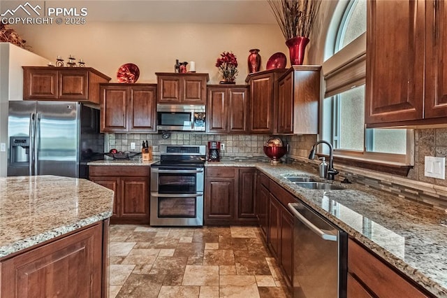 12250 Smoke Bluffs Rd, Peyton, CO 80831 - kitchen featuring appliances with stainless steel finishes, a sink, tasteful backsplash, and light stone counters