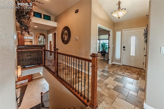 12250 Smoke Bluffs Rd, Peyton, CO 80831 - entryway with stone finish floors, baseboards, and high vaulted ceiling