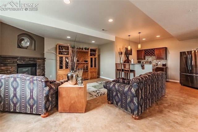 12250 Smoke Bluffs Rd, Peyton, CO 80831 - living area with recessed lighting, baseboards, a stone fireplace, and light carpet