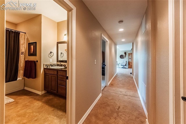 12250 Smoke Bluffs Rd, Peyton, CO 80831 - hallway with light colored carpet, a sink, baseboards, and recessed lighting